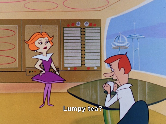 In this animated scene, two characters are engaged in a humorous dialogue. The setting is a futuristic kitchen with sleek, modern design elements. A woman with vibrant orange hair is prominently featured, wearing a striking purple dress with a playful, angular collar. She stands confidently in front of a glass table, expressing surprise or concern with the phrase "Lumpy tea?" 

Seated at the table is a man with red hair, who appears puzzled or distressed, holding a cup in his hands. The decor around them highlights a retro-futuristic theme, with circular shapes and subtle technological motifs. Outside the window, futuristic structures hint at a sci-fi world, contributing to the overall whimsical ambiance of the scene. The episode captures the playful interactions typical of the show, blending humor with its distinctive retro aesthetic.