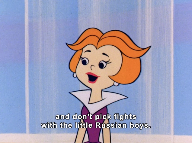 The image features an animated character with a distinctive bobbed hairstyle colored orange with a hint of waves. She has bright, expressive eyes and a wide smile. Dressed in a purple outfit with a stylized collar, the character appears to be mid-speech. The background consists of soft pastel colors, creating a light and playful atmosphere. 

In the foreground, text reads: "and don't pick fights with the little Russian boys." This dialogue suggests a humorous or cautionary tone, fitting within a comedic or animated context. The character's expression conveys a mix of concern and jest, typical of animated storytelling aimed at engaging viewers with light-hearted family-friendly themes.

#ColdWar 