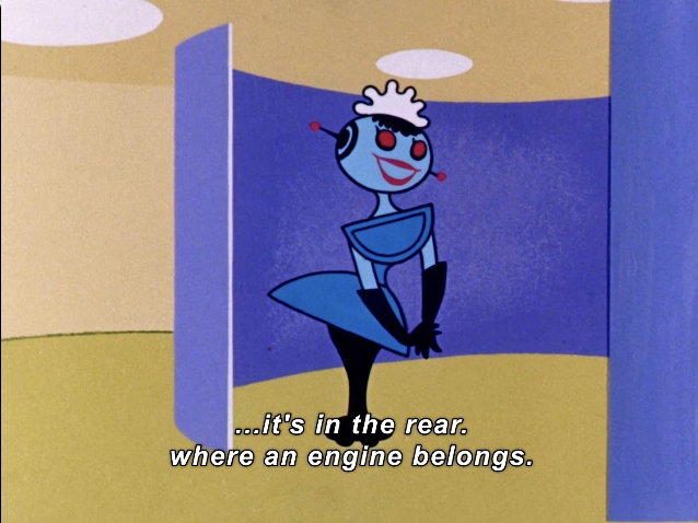 This image features a stylized animated character with a blue skin tone and a retro design, reminiscent of mid-20th-century animation. The character has large, expressive eyes and a smiling mouth, exuding a cheerful and playful demeanor. She is dressed in a distinctive outfit with a wide, flared skirt and long gloves, contributing to her whimsical appearance.

The background consists of simple, geometric shapes in soft pastel colors, creating a light and engaging atmosphere. One wall is a vibrant blue, complementing the character's attire, while the floor has a warm, rounded shape that adds to the playful environment.

Text at the bottom reads: "...it's in the rear. where an engine belongs," suggesting a humorous or contextual reference within the animated scene. This visual composition effectively conveys a sense of fun and imagination, typical of animated storytelling aimed at a broad audience.

#Sexism #MaleGaze #RobotFetish