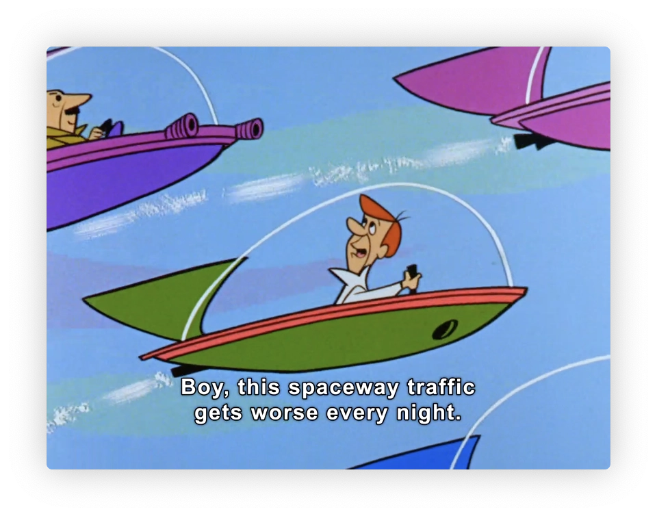 This image is a snapshot from an animated cartoon showing three characters in futuristic flying cars stuck in traffic. The character in the foreground is expressing his frustration, saying, "Boy, this spaceway traffic gets worse every night." The cars are stylized, with slim, elongated designs and soft pastel colors. The sky in the background is blue with white clouds, giving an airy and light atmosphere to the scene. This style of animation and the theme of futuristic space cars is reminiscent of mid-20th century animated shows that often explored themes of science fiction mixed with everyday life scenarios.