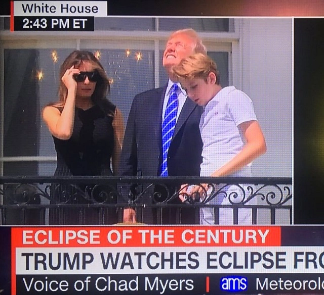 Drumpf first family, first office term, on balcony for the solar eclipse.  DJT is squinting and looking directly at the sun.