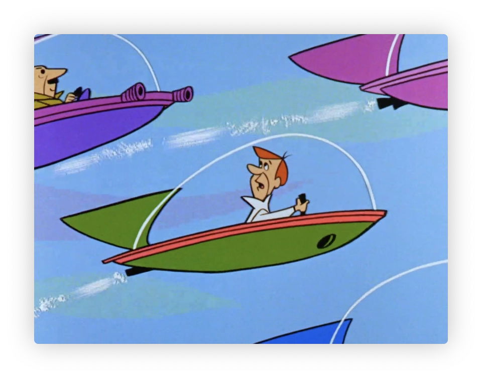 The image shows a scene from a classic animated series featuring three characters in futuristic flying cars. The cars are stylized with elongated shapes and vibrant colors, including pink, green, and red. One of the characters, visible in the foreground, is animated with an expression of either surprise or urgency. This scene depicts a dynamic moment, possibly a race or chase, indicative of the series' affection for portraying whimsical technology and high-energy scenarios.