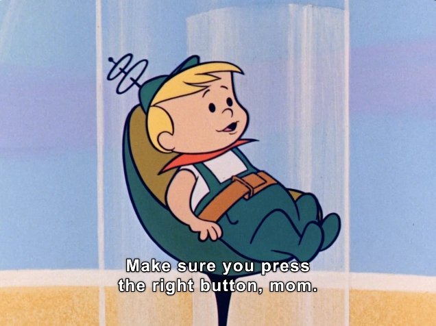 In this lighthearted animated scene, a young boy with short blonde hair and big expressive eyes is seated comfortably in a futuristic, pod-like chair. He is wearing a playful outfit that features a blue shirt and green overalls, along with a red collar that adds a vibrant touch. The background showcases a stylized, colorful environment with soft pastel colors, suggesting a whimsical outer space theme.

The boy appears to be speaking to a figure out of view, urging them to "Make sure you press the right button, mom." His expression conveys a mix of innocence and seriousness, emphasizing the importance of his statement. Above his head, a quirky antenna-like design reinforces the image's playful tone. 

This scene captures a charming moment filled with humor and curiosity, typical of classic animated series aimed at family audiences, making it an engaging snapshot of creativity and childhood adventures.