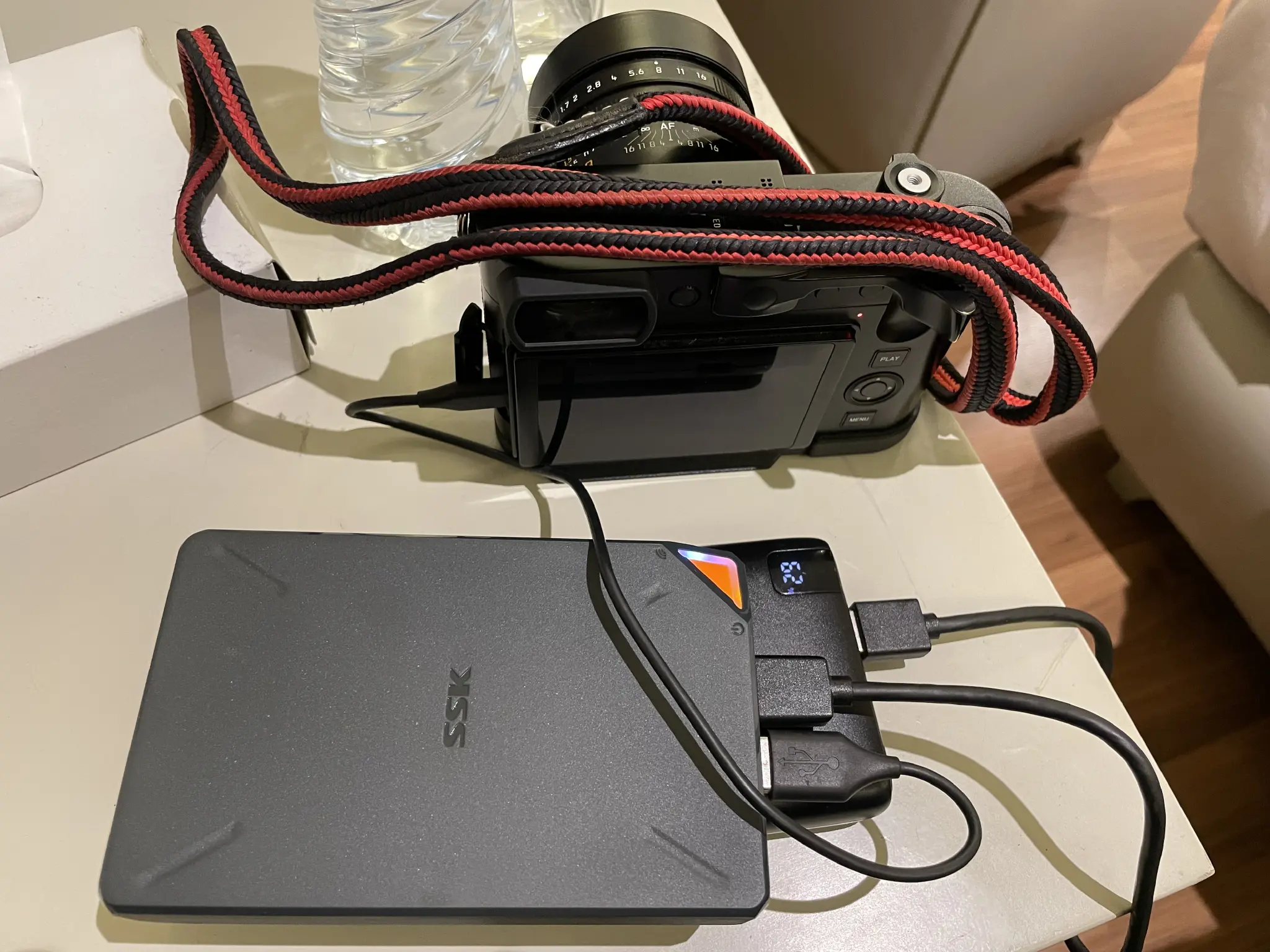 Camera connected via usb to a wireless portable nas, which is also connected to an external battery to keep the drive’s internal one topped up.  Wireless is just a wishful aspirational figure of speech.  Like paperless office. 