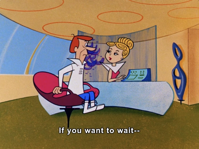In this animated scene, a character resembling a futuristic man is seated in a stylish, oversized chair with a vibrant pink upholstery. He has a distinct hairstyle and is wearing a sleek, white uniform with a collar, giving off a retro-futuristic vibe. Opposite him stands a woman with elegant blonde hair styled in a classic updo. She is dressed in a chic outfit featuring a white top with a high neckline. The setting showcases a modern, minimalist reception area with rounded architecture and soft, warm colors, including beige and blue tones. The background features a uniquely designed sculpture, enhancing the futuristic ambiance. The woman appears poised and professional as she speaks to the man, indicating a conversation about waiting, while a digital console is situated on her desk. The dialogue caption reads, "If you want to wait--" suggesting an interaction typical of a service environment in a sci-fi context.